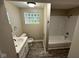 Cozy bathroom with neutral walls, a shower and glass block window at 3628 Breen Dr, Indianapolis, IN 46235