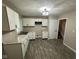 Updated kitchen with white cabinetry, laminate countertops, and views to the stairs at 3628 Breen Dr, Indianapolis, IN 46235