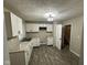Bright kitchen with white cabinets, gray countertops, and modern flooring at 3628 Breen Dr, Indianapolis, IN 46235