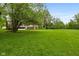 Expansive backyard featuring a well-maintained lawn and distant home view at 502 S Harrison St, Alexandria, IN 46001