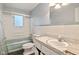 This is a bathroom with a tub and shower, toilet, and sink with a large mirror and tile backsplash at 502 S Harrison St, Alexandria, IN 46001