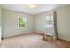 Cozy bedroom featuring neutral walls, carpeted flooring, and two windows providing natural light at 502 S Harrison St, Alexandria, IN 46001