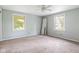 Cozy bedroom with a ceiling fan and natural light from two windows, perfect for relaxation at 502 S Harrison St, Alexandria, IN 46001
