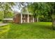 Inviting brick home with a lush green lawn and covered front porch at 502 S Harrison St, Alexandria, IN 46001