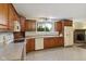 Traditional kitchen featuring wood cabinetry, window with natural light, and classic appliances at 502 S Harrison St, Alexandria, IN 46001