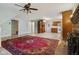 Spacious living room with an oriental rug and open floorplan to a kitchen with wood cabinets at 502 S Harrison St, Alexandria, IN 46001