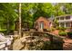 Inviting backyard patio with a fire pit, multiple seating areas, and lush greenery, perfect for outdoor entertaining at 535 W 93Rd St, Indianapolis, IN 46260