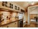 Charming bar area with custom cabinetry, wooden countertop, and wine storage at 535 W 93Rd St, Indianapolis, IN 46260