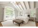 Bright bedroom with vaulted ceilings, large windows, and a comfortable bed at 535 W 93Rd St, Indianapolis, IN 46260