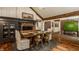Inviting dining area with a rustic wood table, chairs, fireplace, and view of the adjacent rooms at 535 W 93Rd St, Indianapolis, IN 46260