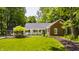 Charming brick home with a manicured lawn and a tree in front, creating a picturesque and inviting curb appeal at 535 W 93Rd St, Indianapolis, IN 46260