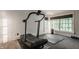 Well-lit home gym featuring a treadmill, rubber mat, and ample space for exercise at 535 W 93Rd St, Indianapolis, IN 46260