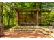 Outdoor hot tub on a brick patio with privacy screen and garden, creating a serene and private retreat at 535 W 93Rd St, Indianapolis, IN 46260