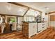 Open-concept kitchen featuring a brick island, granite countertops, white cabinetry, and natural lighting at 535 W 93Rd St, Indianapolis, IN 46260