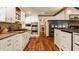 Well-equipped kitchen with stainless steel appliances, custom cabinets, and a breakfast bar with seating at 535 W 93Rd St, Indianapolis, IN 46260