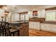Bright kitchen showcasing white cabinets, brick accents, an island with bar seating, and stainless steel appliances at 535 W 93Rd St, Indianapolis, IN 46260