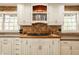 Farmhouse-style kitchen featuring brick backsplash, white cabinetry, open shelving, and wood countertops at 535 W 93Rd St, Indianapolis, IN 46260
