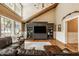 Living room with hardwood floors, large windows, a custom entertainment center, and stylish decor for a comfortable living space at 535 W 93Rd St, Indianapolis, IN 46260