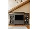 Beautiful built-in media center with storage and shelving in a well-lit living room with natural wood beam and plank ceiling at 535 W 93Rd St, Indianapolis, IN 46260