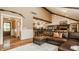 Cozy living room with a leather sectional sofa, brick accents, and open access to the kitchen and entryway at 535 W 93Rd St, Indianapolis, IN 46260
