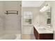 Well-lit bathroom with double vanity, white tile backsplash, and a window offering natural light at 539 Deer Trail Dr, Indianapolis, IN 46217