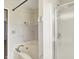Bathroom with tile surround tub and shower with glass door, next to a bedroom at 539 Deer Trail Dr, Indianapolis, IN 46217