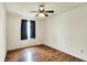 Bright bedroom with wood floors, a ceiling fan, and a window with black-out curtains at 539 Deer Trail Dr, Indianapolis, IN 46217