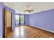 Spacious bedroom featuring wood-look floors, a ceiling fan, and a window with curtains at 539 Deer Trail Dr, Indianapolis, IN 46217