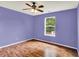 Bedroom featuring wood-look floors, a ceiling fan, and a bright window at 539 Deer Trail Dr, Indianapolis, IN 46217