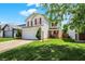 Inviting two-story house featuring a manicured lawn, driveway, and red-accented exterior at 539 Deer Trail Dr, Indianapolis, IN 46217