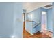 Hallway painted in light blue color showcases wood floors and access to various rooms at 539 Deer Trail Dr, Indianapolis, IN 46217