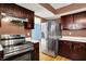 Kitchen with a stainless steel fridge, updated appliances, and wooden cabinets at 539 Deer Trail Dr, Indianapolis, IN 46217