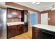 Bright kitchen with a stainless steel refrigerator, dark cabinets, and laminate floors at 539 Deer Trail Dr, Indianapolis, IN 46217