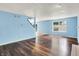Bright living room with hardwood floors, a fireplace, staircase, and large window overlooking the backyard at 539 Deer Trail Dr, Indianapolis, IN 46217