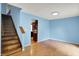 Bright living room features hardwood floors and stairs leading to the upper level at 539 Deer Trail Dr, Indianapolis, IN 46217