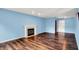 Spacious living room featuring hardwood floors, a fireplace, and light blue walls at 539 Deer Trail Dr, Indianapolis, IN 46217