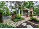 Lush backyard featuring a stone walkway, brick gate, patio, and thriving plants and trees at 5415 Kilmer Ln, Indianapolis, IN 46250