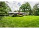 Sprawling backyard featuring a well-maintained lawn, mature trees, and a brick home at 5415 Kilmer Ln, Indianapolis, IN 46250