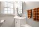 Bright bathroom with a single vanity, storage, and orange towels at 5415 Kilmer Ln, Indianapolis, IN 46250