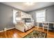 Bedroom with a bunk bed, desk, hardwood floors, and natural light at 5415 Kilmer Ln, Indianapolis, IN 46250