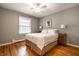 Cozy bedroom with a queen-sized bed, hardwood floors, and natural light at 5415 Kilmer Ln, Indianapolis, IN 46250