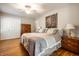 Serene bedroom features hardwood floors, a neutral color scheme, and built-in closet storage at 5415 Kilmer Ln, Indianapolis, IN 46250