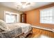 Comfortable bedroom with hardwood floors, plenty of natural light, a ceiling fan, and closet space at 5415 Kilmer Ln, Indianapolis, IN 46250