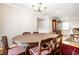 Elegant dining room with a large wooden table, vintage china cabinet, and hardwood flooring at 5415 Kilmer Ln, Indianapolis, IN 46250