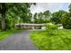 Charming brick home with a winding driveway and beautiful landscaping creates an inviting entrance at 5415 Kilmer Ln, Indianapolis, IN 46250