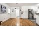 Bright kitchen with white cabinetry, stainless steel appliances, a door to the backyard, and hardwood floors at 5415 Kilmer Ln, Indianapolis, IN 46250