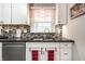 Updated kitchen with stainless steel appliances, granite countertops, and a mosaic backsplash at 5415 Kilmer Ln, Indianapolis, IN 46250