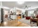 Open layout featuring the kitchen, living room with a fireplace, and hardwood floors throughout the home at 5415 Kilmer Ln, Indianapolis, IN 46250