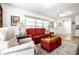Cozy living room features a red sofa, area rug, white walls, and natural light from the windows at 5415 Kilmer Ln, Indianapolis, IN 46250