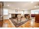 Spacious living room with hardwood floors, a brick fireplace, and comfortable seating arrangement at 5415 Kilmer Ln, Indianapolis, IN 46250